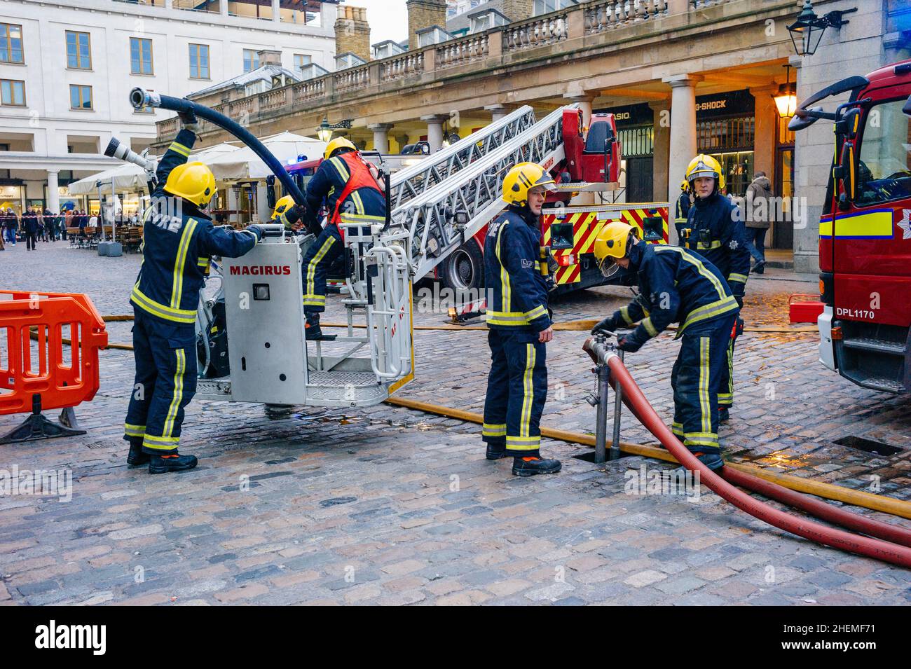 London fire brigade pack up after an emergency call out in Covent Garden, London. Stock Photo