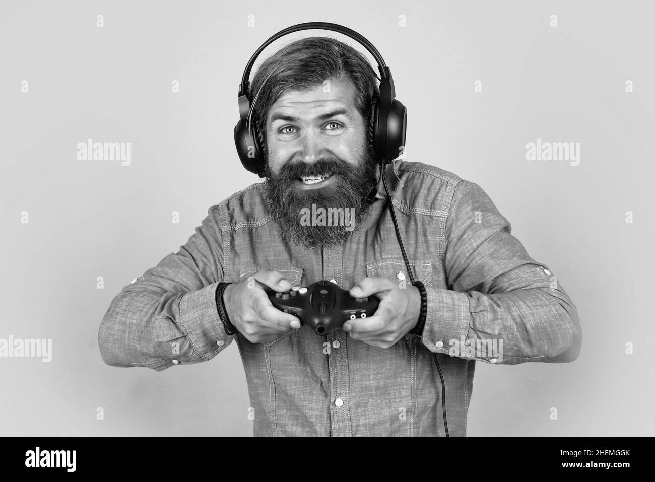 Play it all. man in headphones with console. hobby. just have fun. new technology in modern life. happy gamer play computer games. man playing video Stock Photo