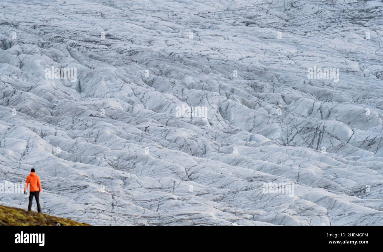 Unrecognizable tourist rear view looking to a massive glacier Stock Photo