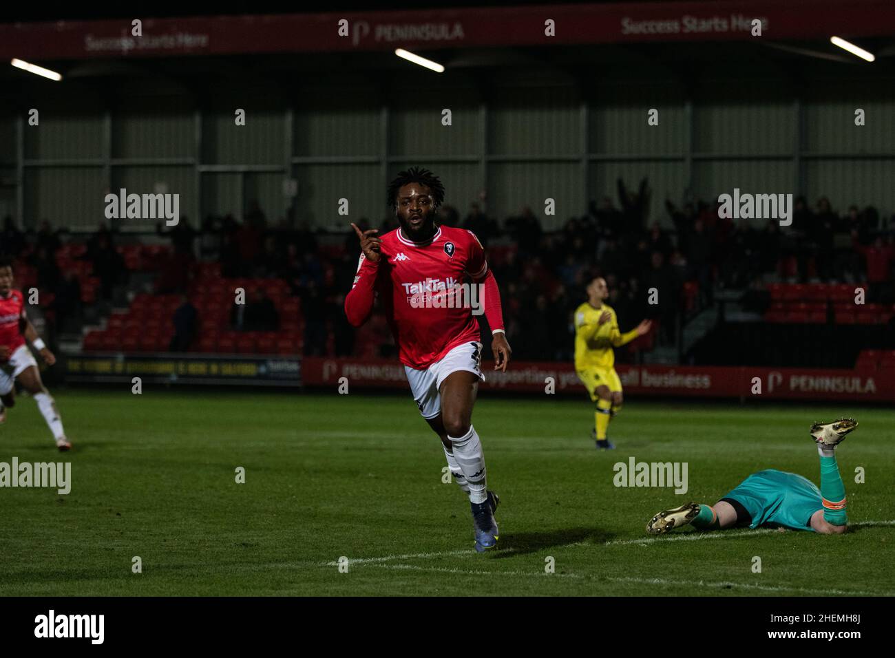 Salford, UK. 11th Jan 2022. Aramide Oteh scores the opening goal for Salford, after an error from Tranmere goalkeeper Joel Torrence, as the hosts lead 1-0 at half time. Stock Photo