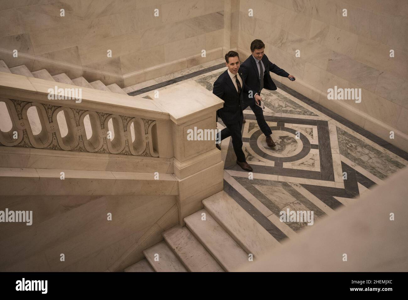 Washington, United States. 11th Jan, 2022. U.S. Sen. Josh Hawley R-MO, and a staffer walk down the stairs after exiting the Kennedy Caucus Room for the Republican Luncheon meeting on Capitol Hill in Washington, DC on Tuesday, January 11, 2022. Photo by Ken Cedeno/UPI . Credit: UPI/Alamy Live News Stock Photo