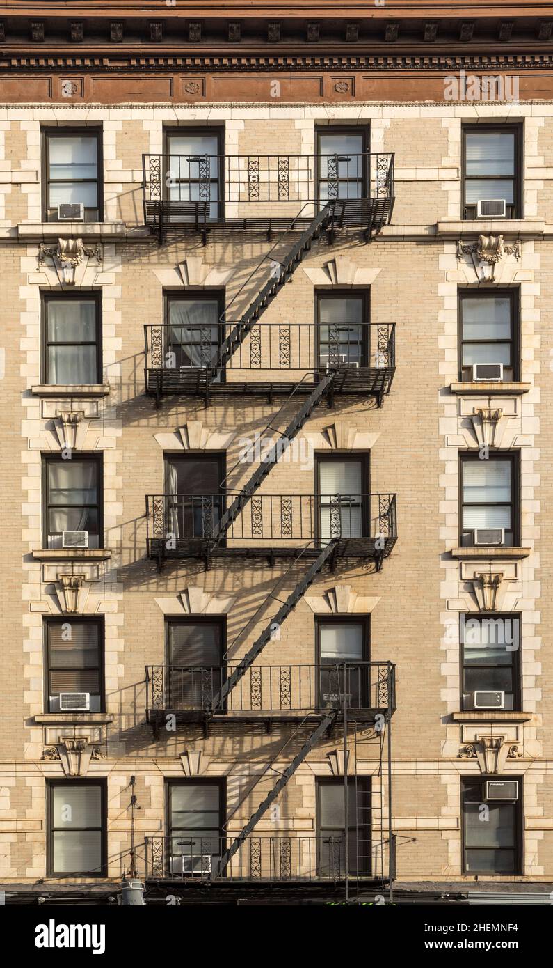 detail of old vintage brick wall facade with fire ladder and iron