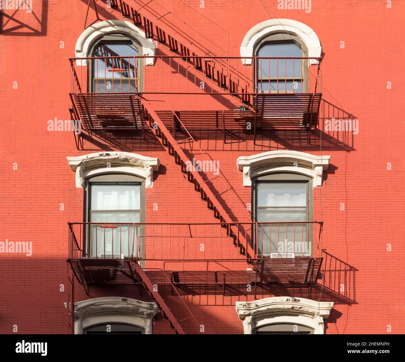 detail of old vintage brick wall facade with fire ladder and iron