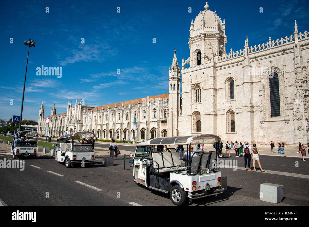 a Tuk Tuk Taxi in front of the Mosteiro dos Jeronimos in Belem near the City of Lisbon in Portugal.  Portugal, Lisbon, October, 2021 Stock Photo