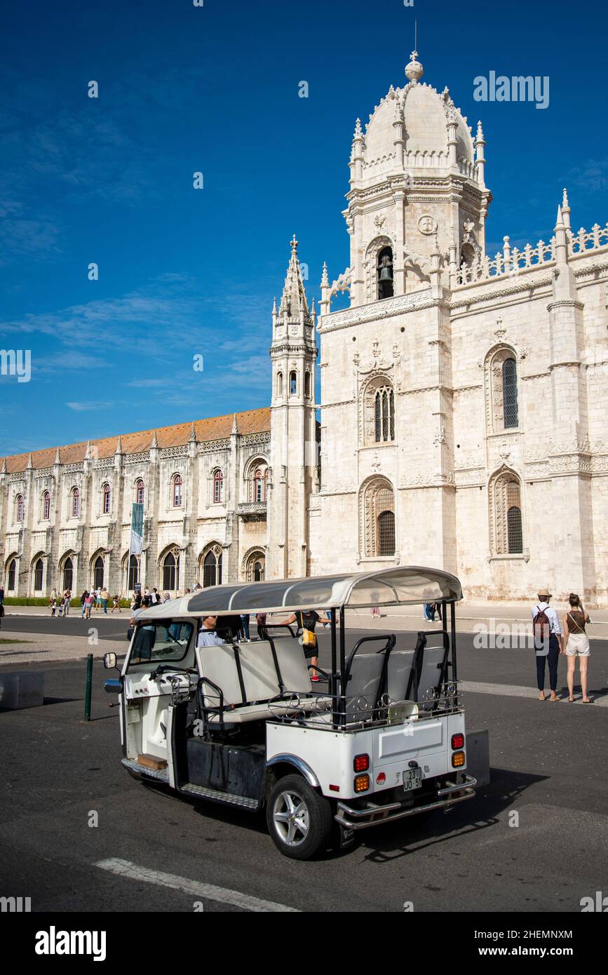 a Tuk Tuk Taxi in front of the Mosteiro dos Jeronimos in Belem near the City of Lisbon in Portugal.  Portugal, Lisbon, October, 2021 Stock Photo