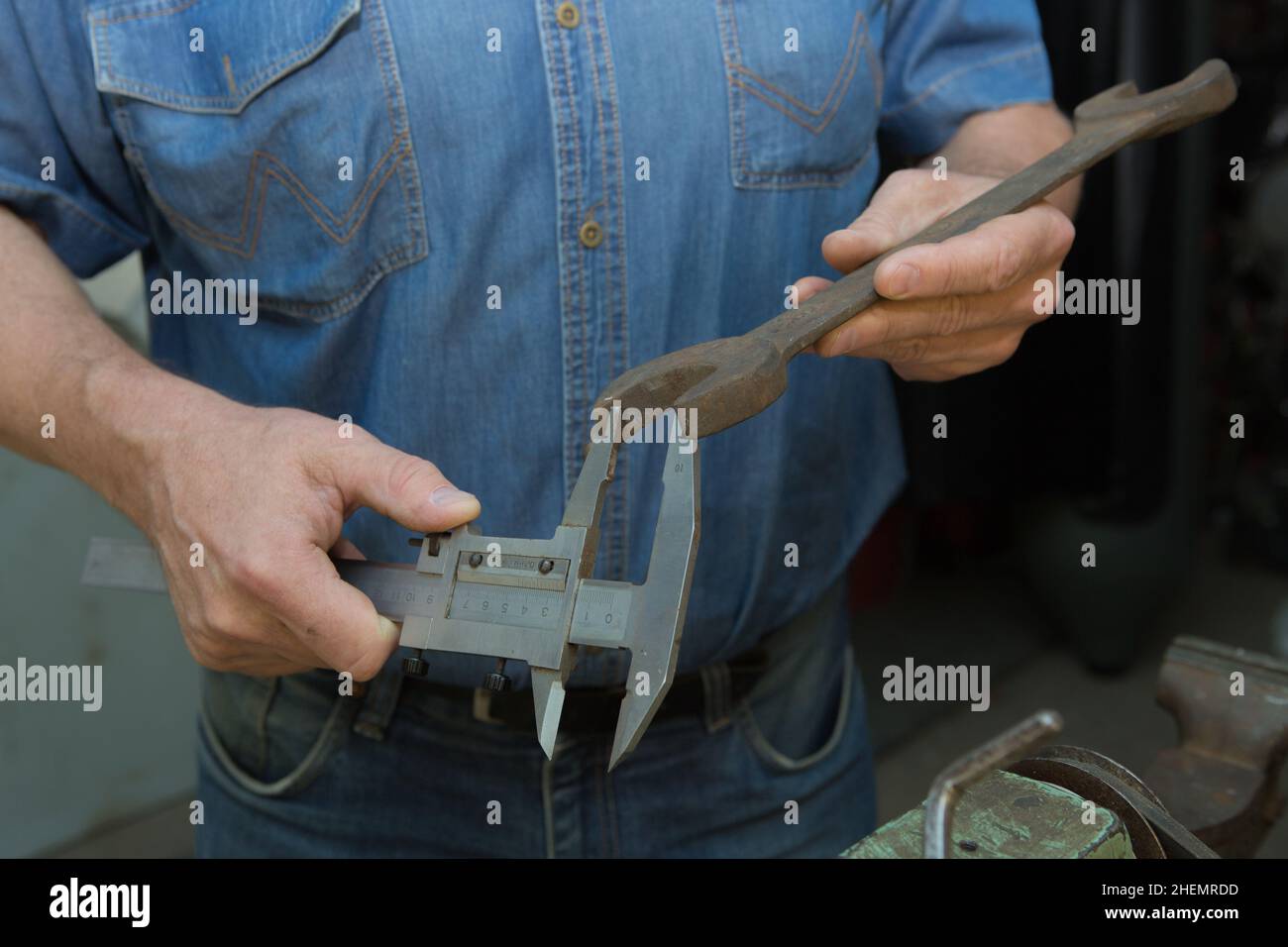 Worker Using Calipers Working with a caliper. Master's hands at work. Home workshop Stock ...