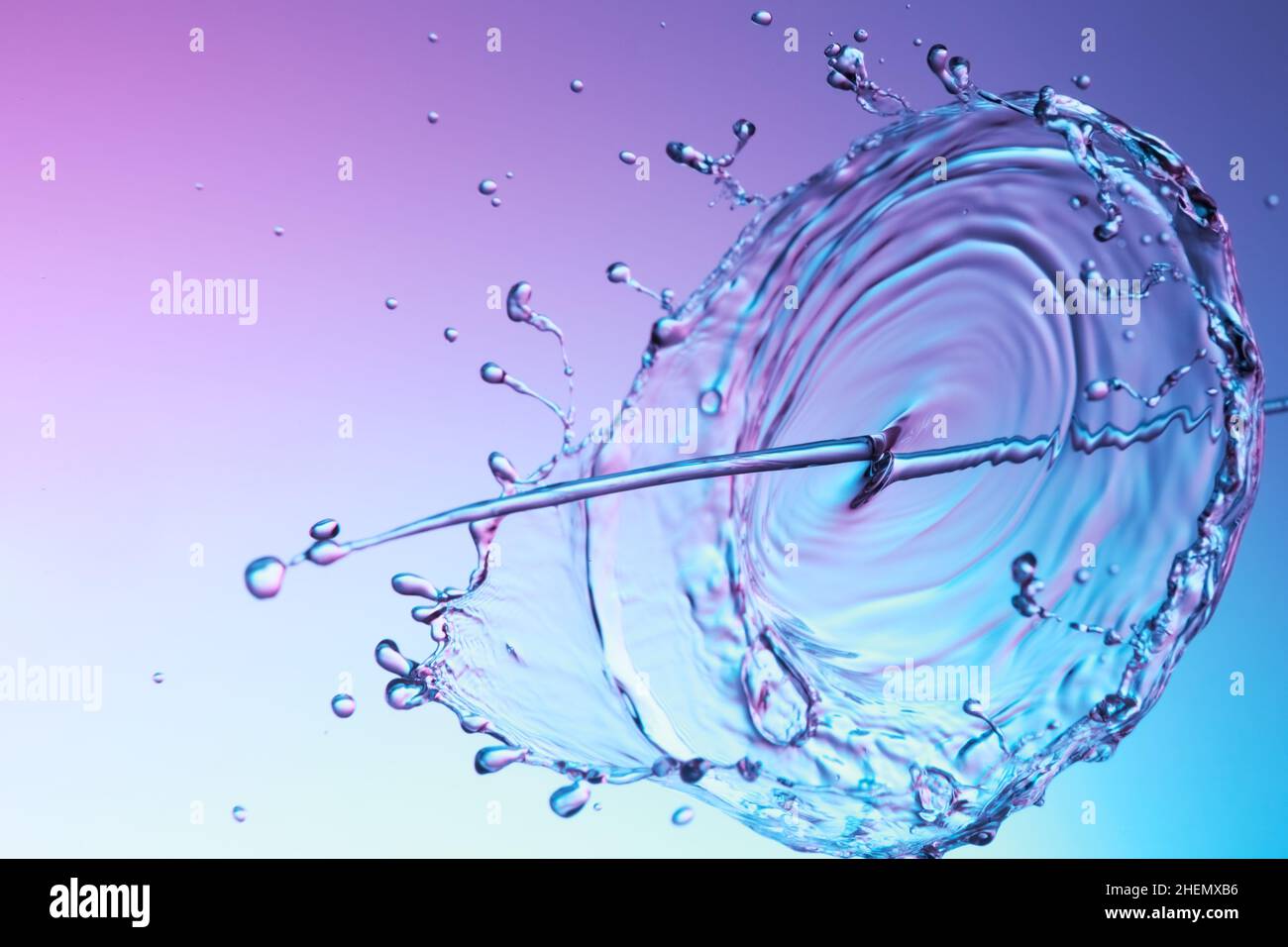 Clear water liquid splash on a red blue background Stock Photo