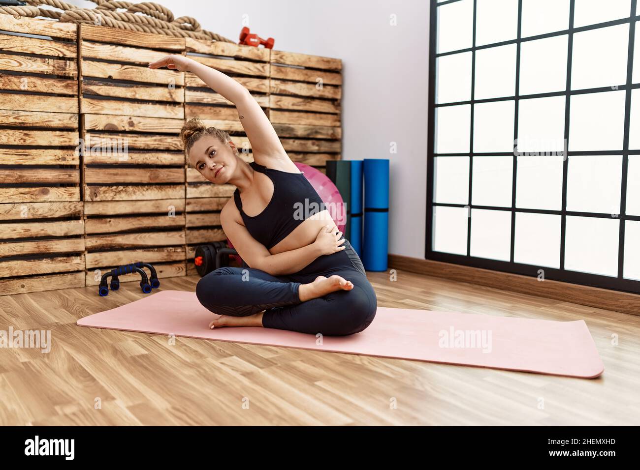 Young blonde girl stretching at sport center Stock Photo - Alamy