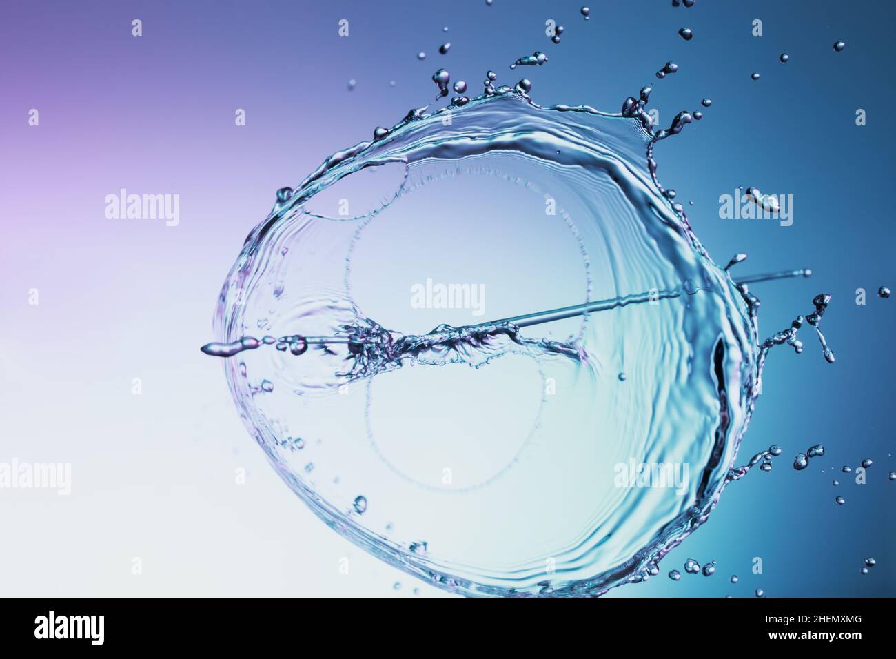 Clear water liquid splash on a blue background Stock Photo