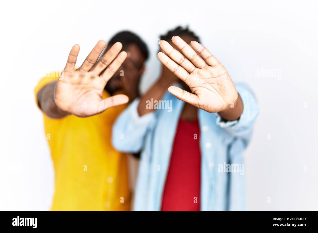 Young african american couple wearing casual clothes covering eyes with ...