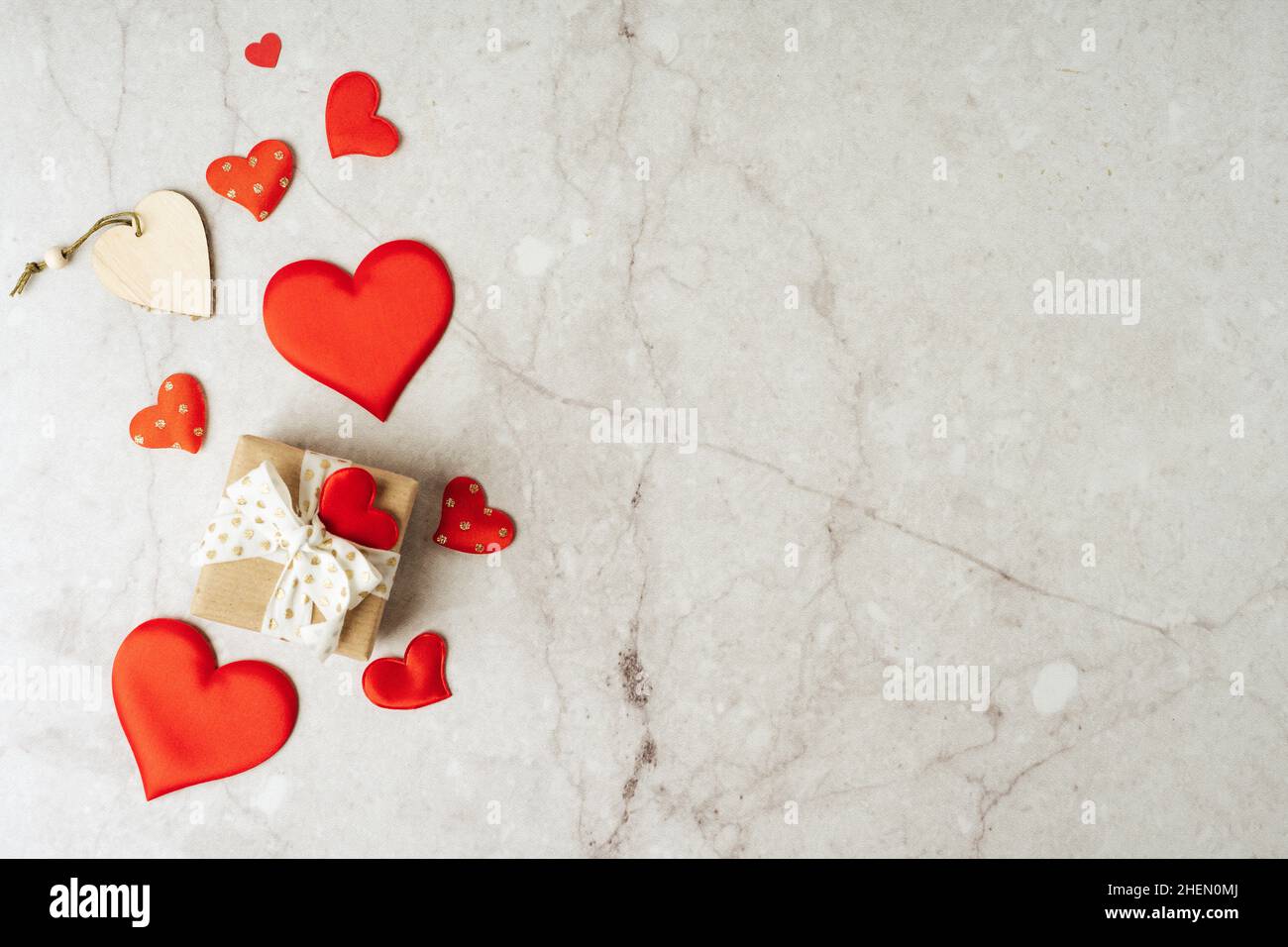 Background with gift and hearts with free space for text on concrete grey background. Valentines day concept. Mother's Day concept. Greetings card Stock Photo