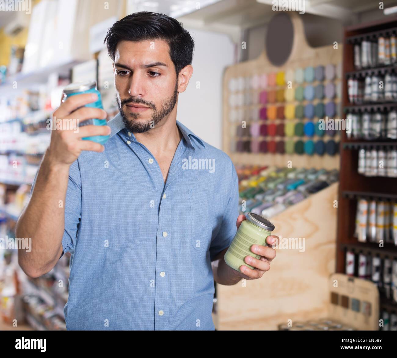 Focused young man paints hi-res stock photography and images - Alamy