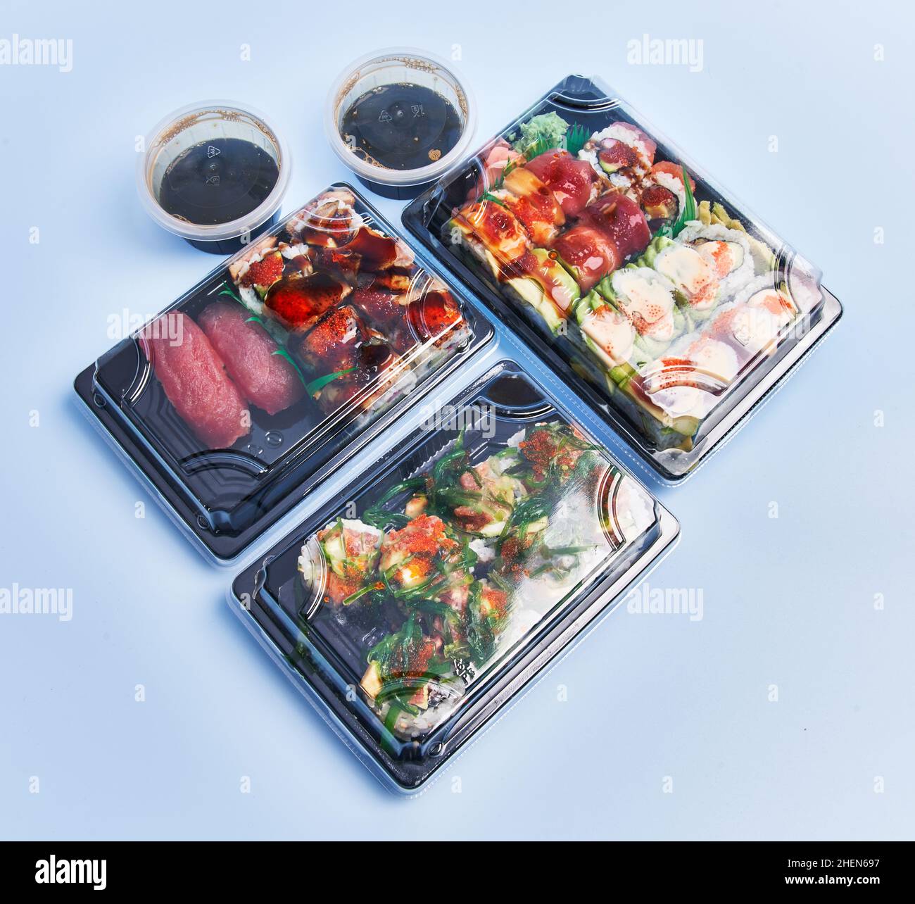Delivery trays of sushi over blue background Stock Photo Alamy