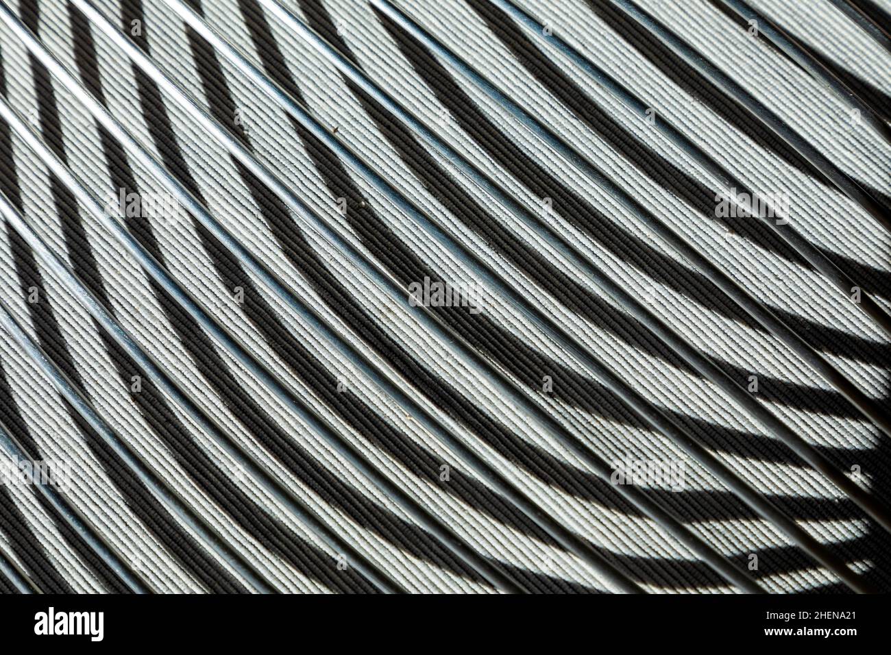 shadow of a silver chair in detail gives a abstract harmonic pattern Stock Photo