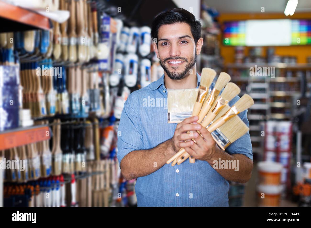 buyer holding various paint brushes Stock Photo Alamy