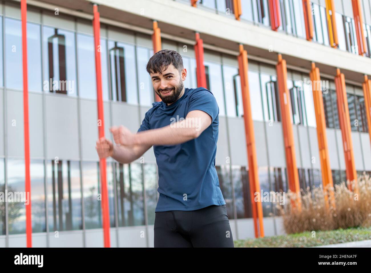 Young man doing their stretches before training. Stock Photo