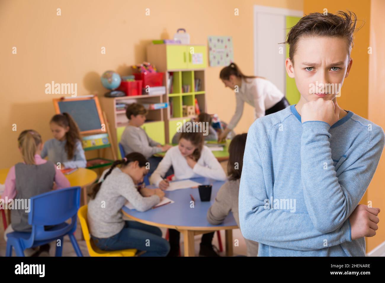 Unhappy schoolboy standing, elementary age children drawing Stock Photo ...