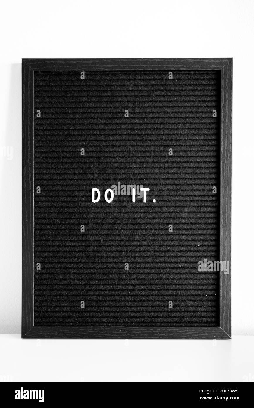Do it inspirational encouragement quote black letter board white letters white background Stock Photo