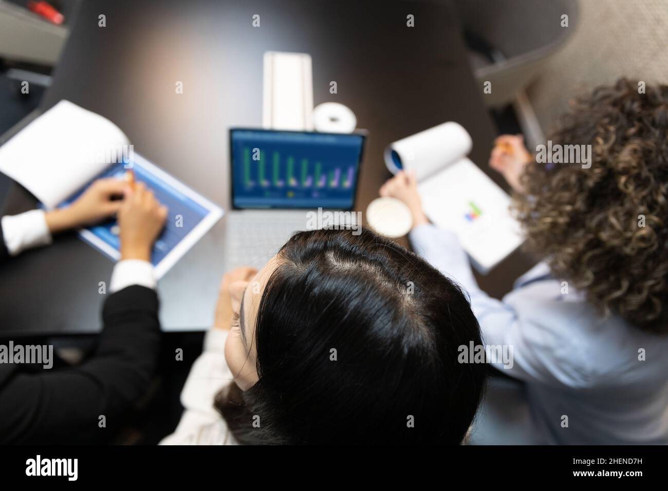 Unrecognized female office workers using digital tablet during a meeting. Stock Photo