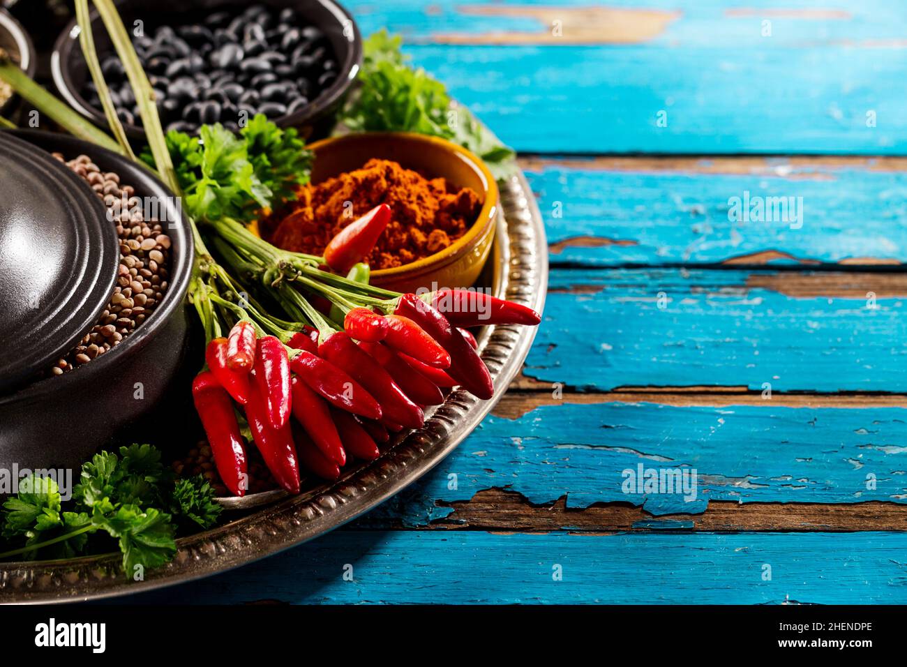 Beautiful Tasty Appetizing Ingredients Spices Grocery Red Chilli Pepper Black Bowls for Cooking Healthy Kitchen. Stock Photo