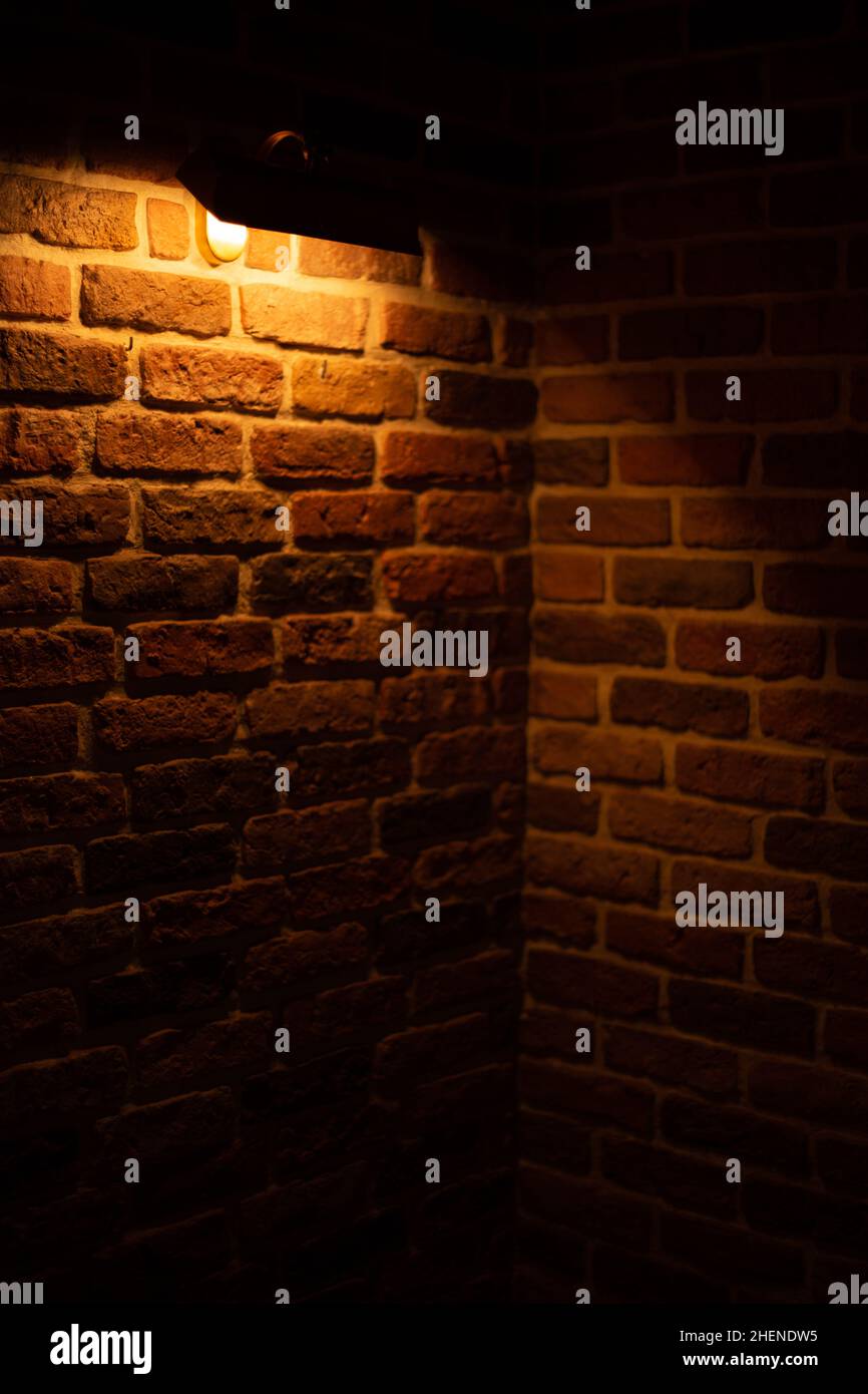 Brick wall illuminated by warm light from a lamp Stock Photo - Alamy