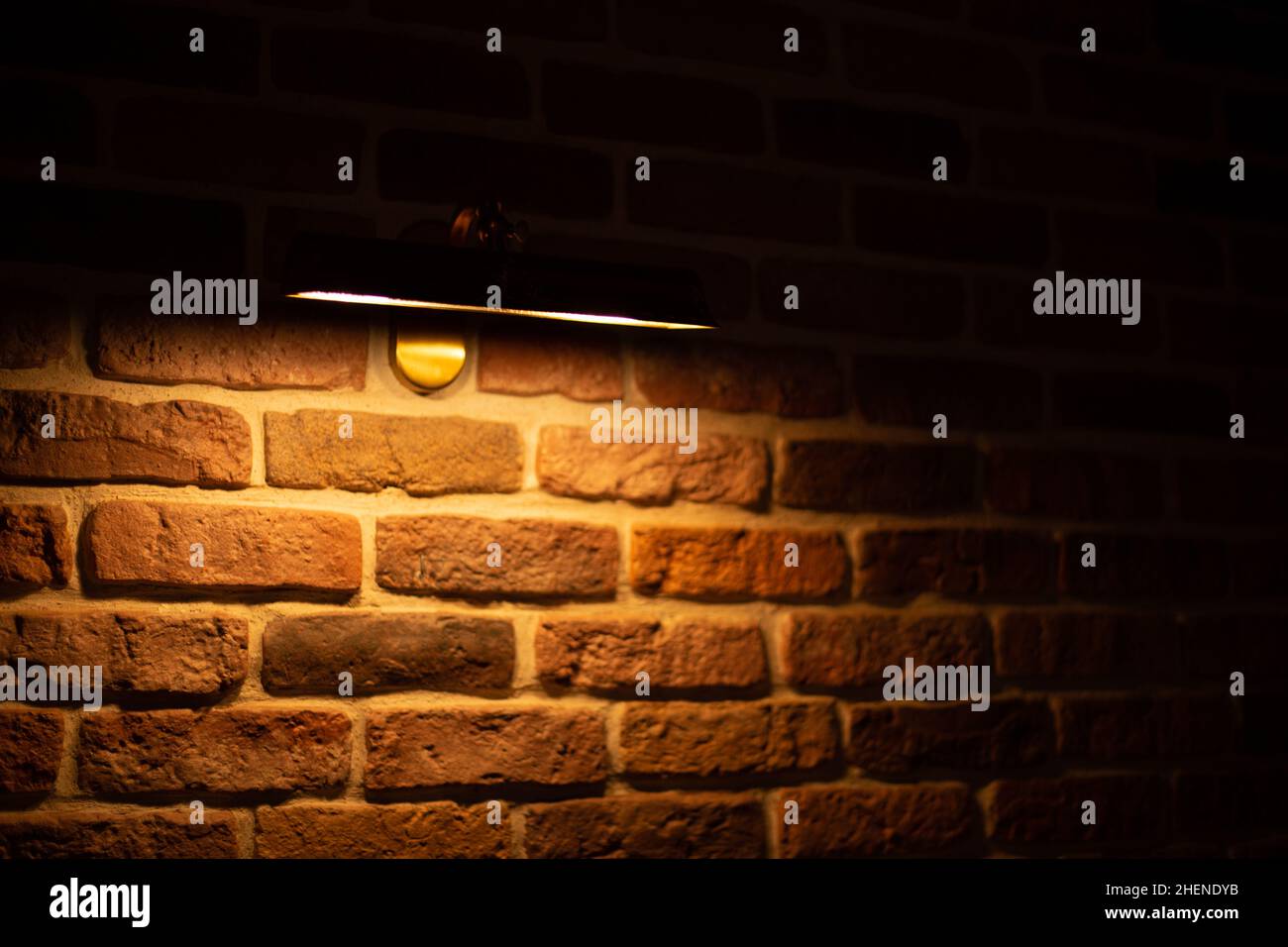 Brick wall illuminated by warm light from a lamp Stock Photo - Alamy