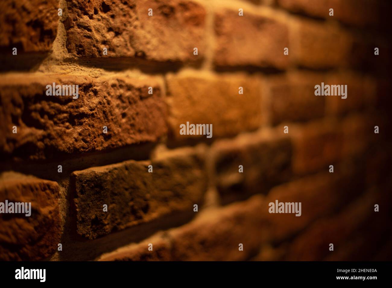 Brick wall illuminated by warm light from a lamp Stock Photo - Alamy