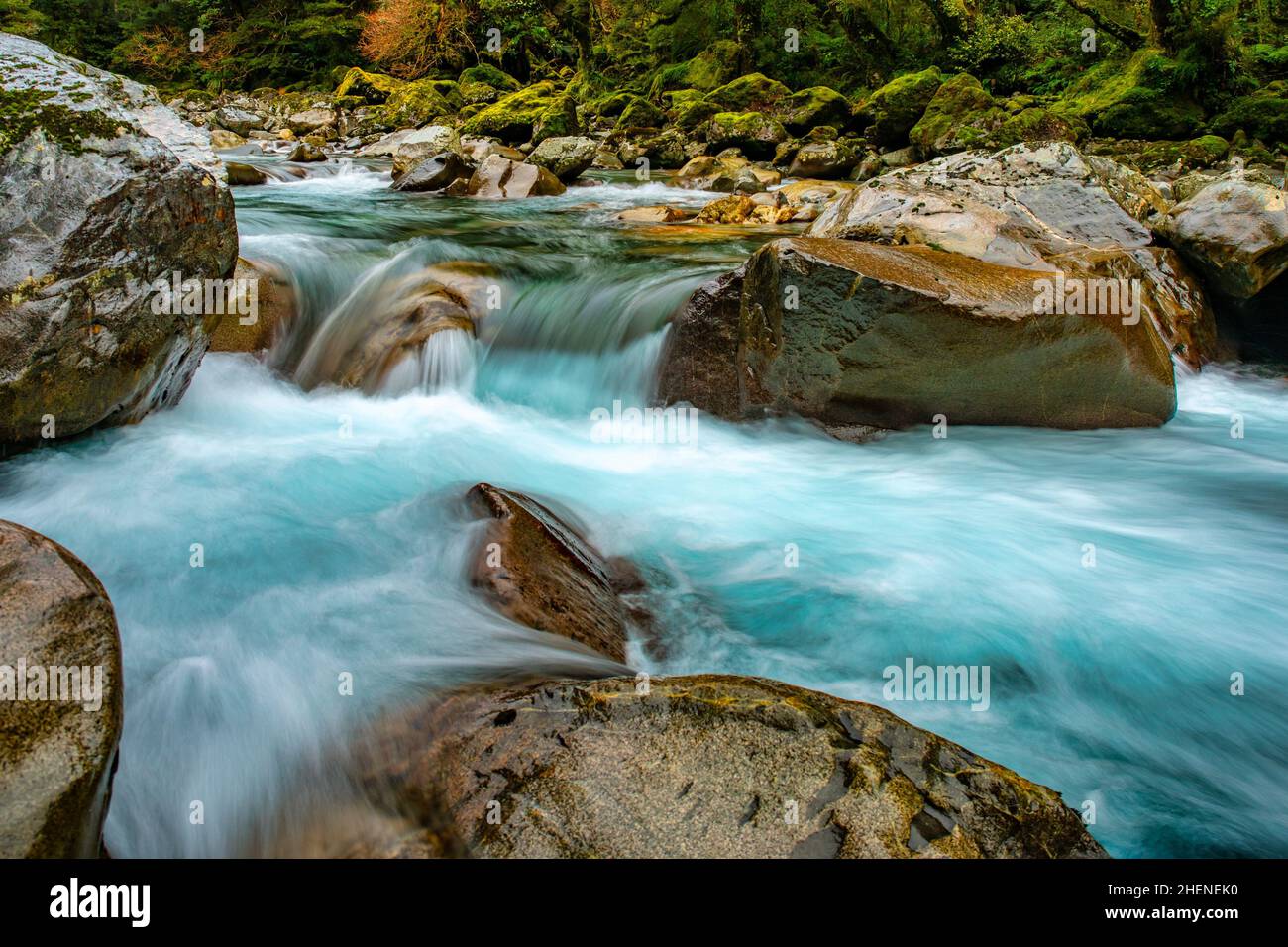 The dreamy long exposure of the river rushing through the rocks in the river in the forest Stock Photo