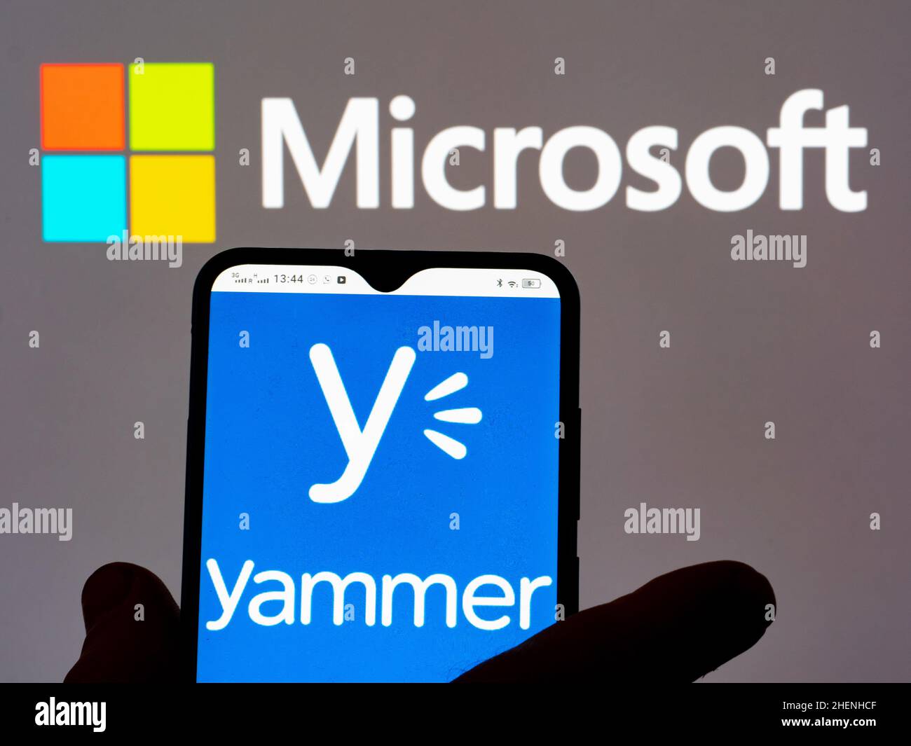 Hand Holding Smartphone Displaying Logo Of Yammer Edi vrogue.co