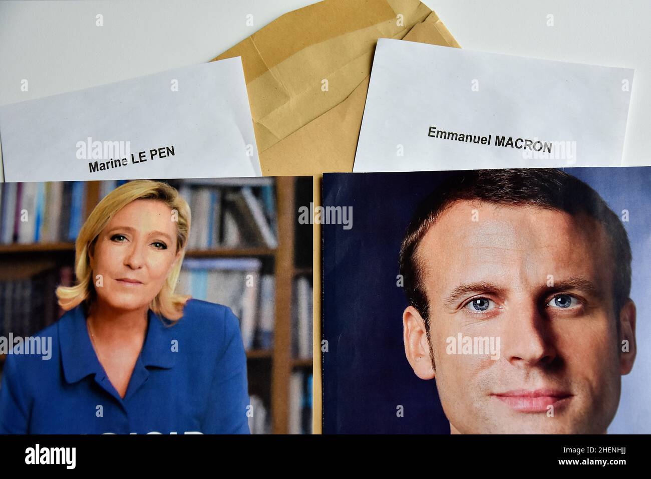 France. 10th Jan, 2022. In this photo illustration, Marine Le Pen and Emmanuel Macron's ballot papers and election posters are seen displayed. While he is not yet officially a candidate for his re-election, the President of the French Republic, Emmanuel Macron is leading the polls for the presidential elections of 2022 with 27% of the voting intentions in front of the candidate of the National Rally (RN) Marine Le Pen (17.5%). The first round of the election of the President of the Republic will take place on April 10, 2022. Credit: SOPA Images Limited/Alamy Live News Stock Photo