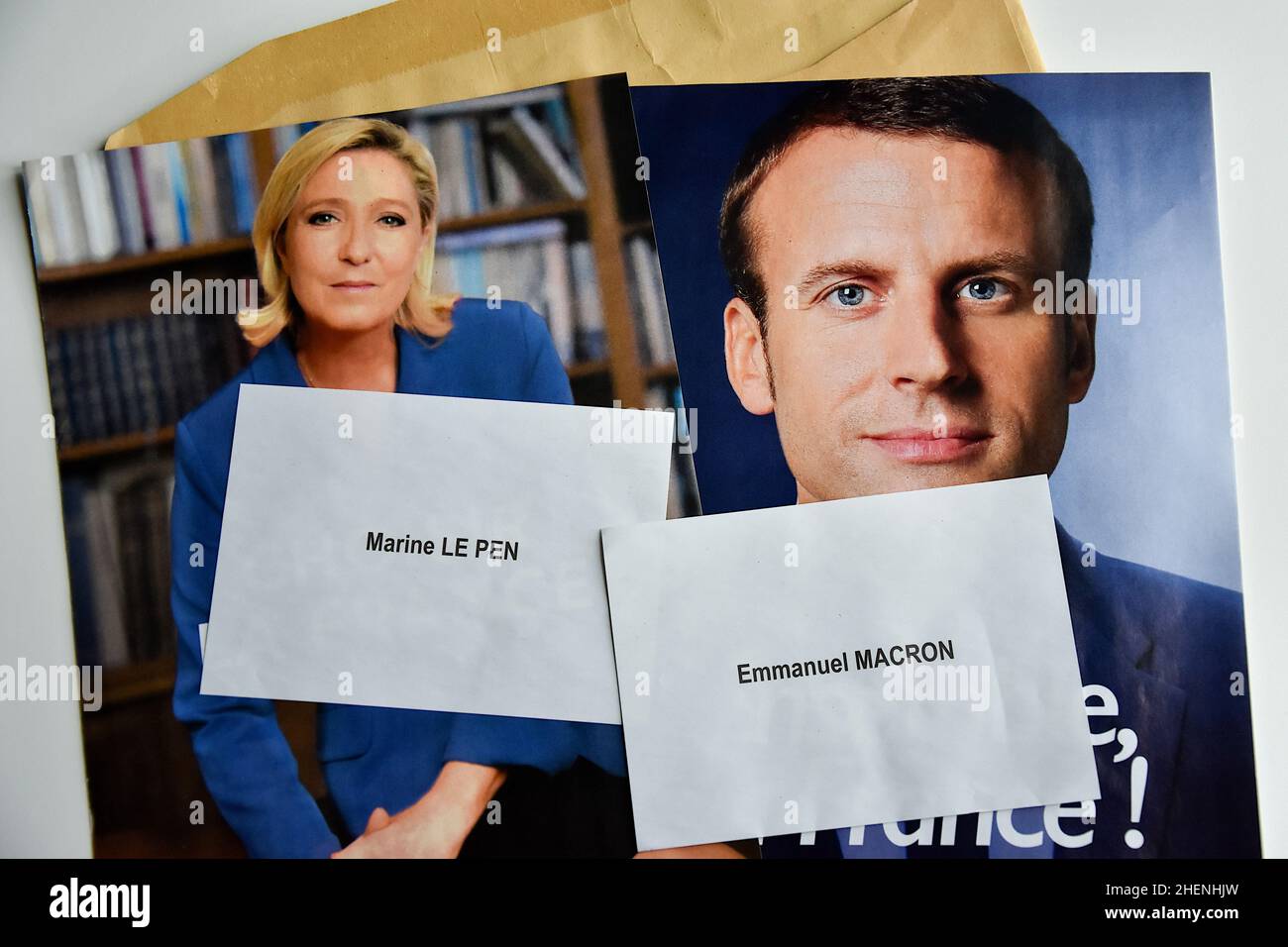 France. 10th Jan, 2022. In this photo illustration, Marine Le Pen and Emmanuel Macron's ballot papers and election posters are seen displayed. While he is not yet officially a candidate for his re-election, the President of the French Republic, Emmanuel Macron is leading the polls for the presidential elections of 2022 with 27% of the voting intentions in front of the candidate of the National Rally (RN) Marine Le Pen (17.5%). The first round of the election of the President of the Republic will take place on April 10, 2022. Credit: SOPA Images Limited/Alamy Live News Stock Photo