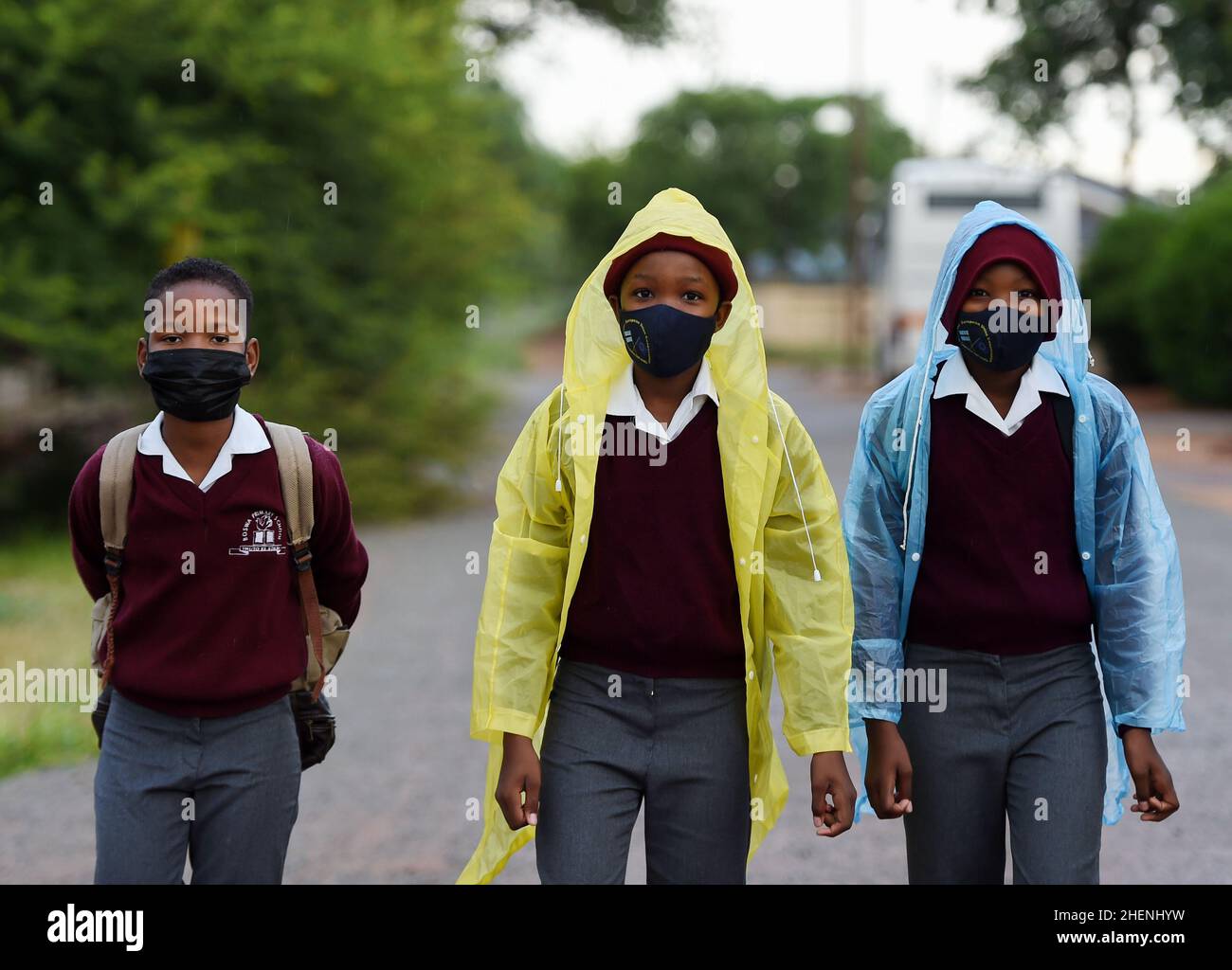 Gaborone, Botswana. 11th Jan, 2022. Students wearing masks walk to ...