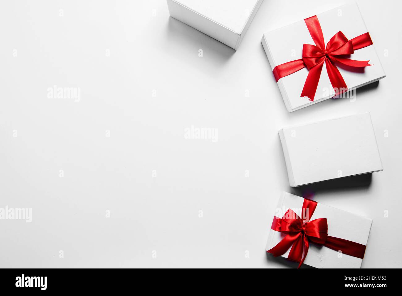 White gift box with red ribbon with white background Stock Photo - Alamy