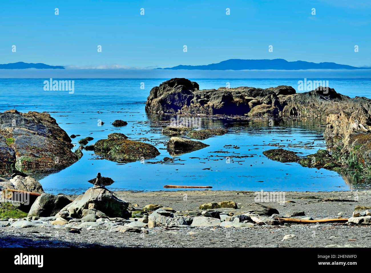 A landscape image of a rocky beach on the rugged west coast of Vancouver Island looking toward the Pacific Ocean. Stock Photo