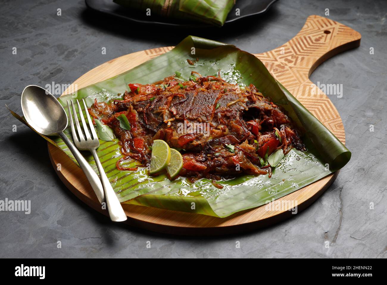 Meen Pollichathu or fish pollichathu, tasty kerala dish, fish with masala cooked in banana leaf. Stock Photo
