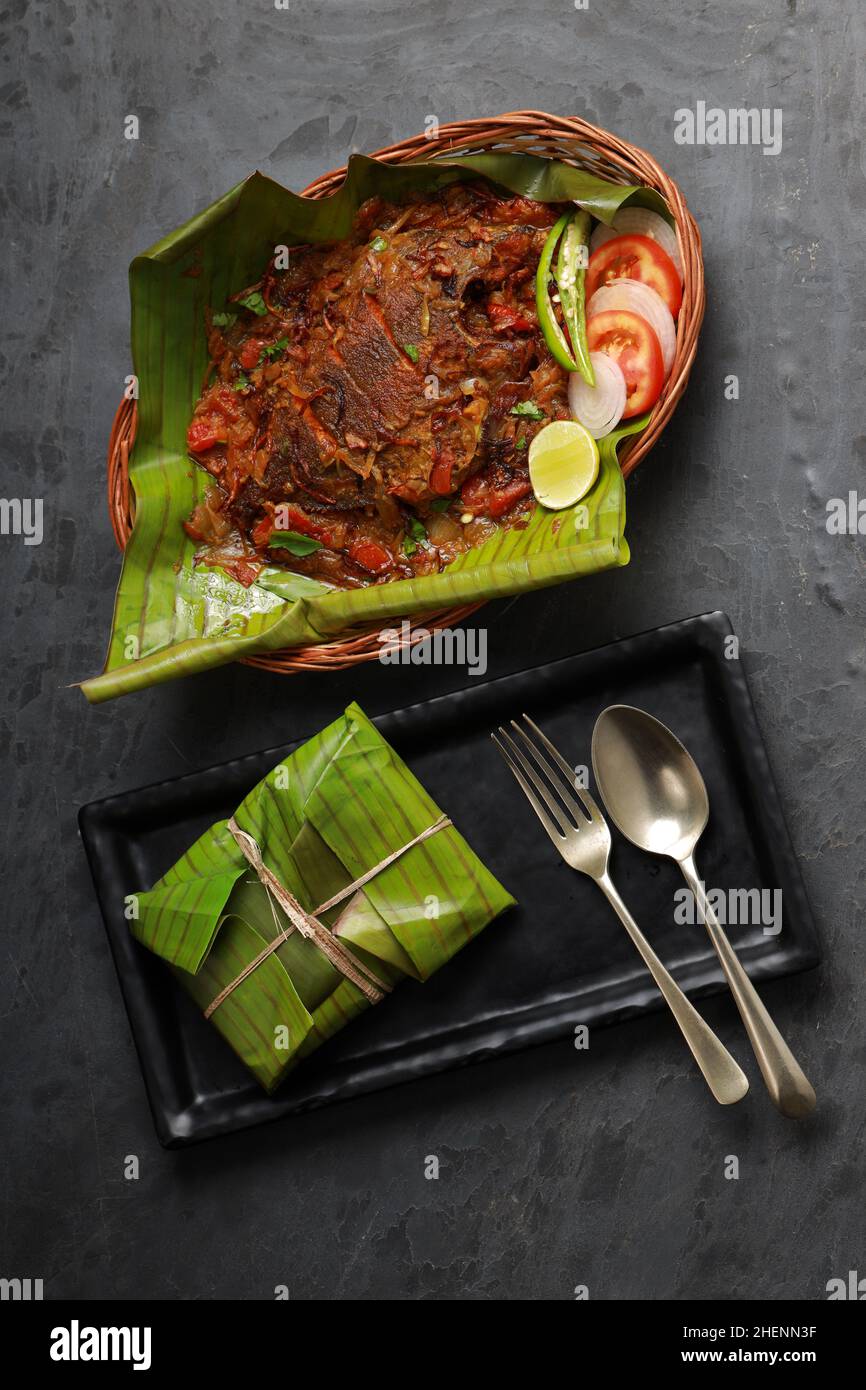 Meen Pollichathu or fish pollichathu, tasty kerala dish, fish with masala cooked in banana leaf. Stock Photo