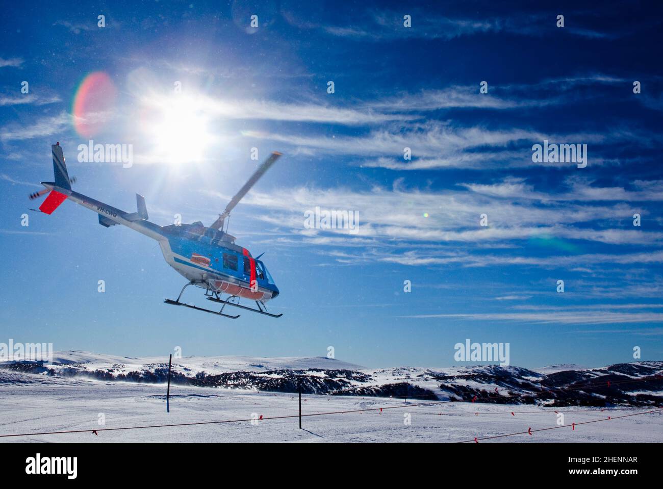 Helicopter shuttle taking off from Falls Creek en route to Mount Hotham in Victoria's high country. Stock Photo