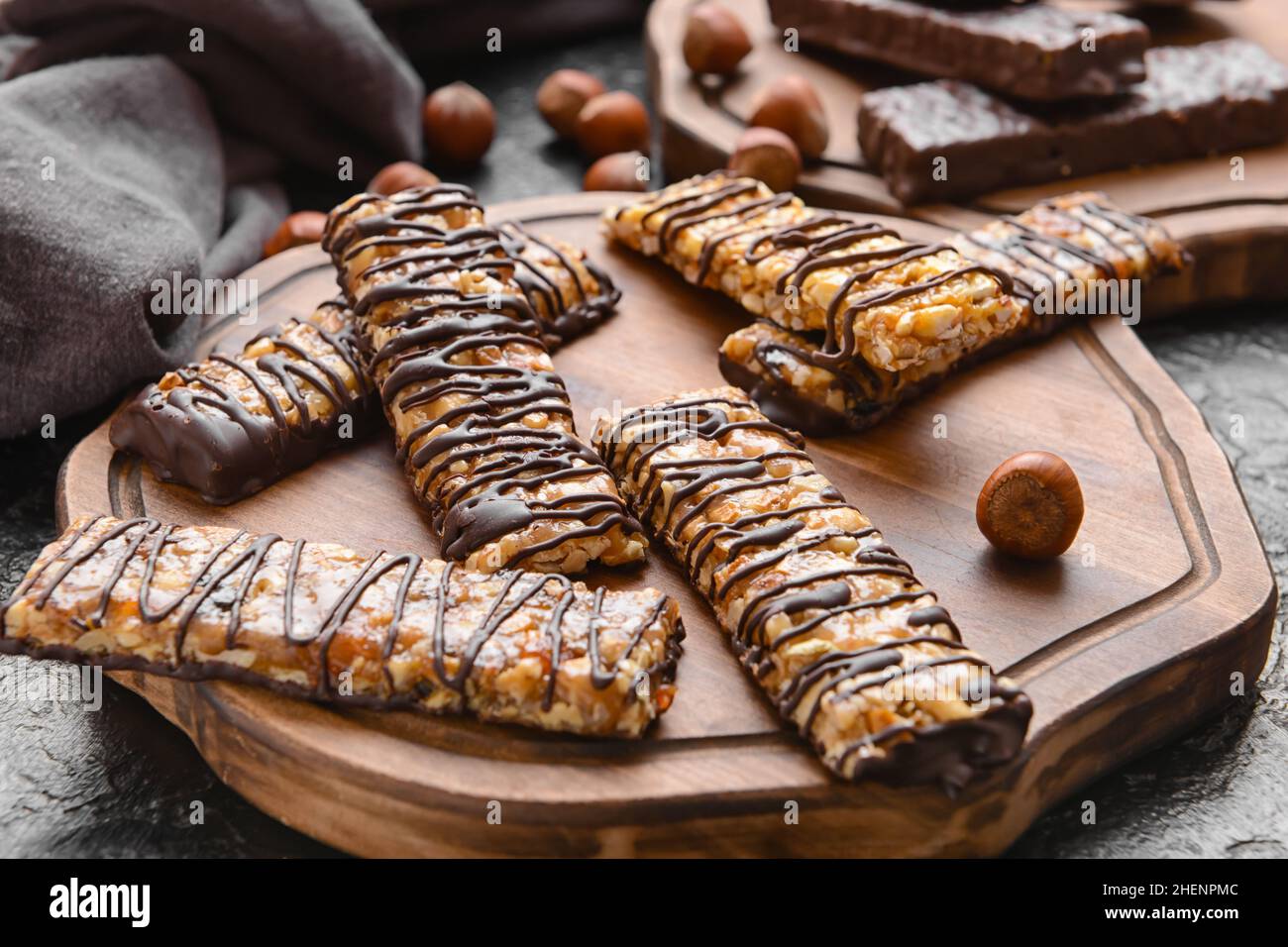 Board with tasty chocolate nut bars on dark background Stock Photo - Alamy