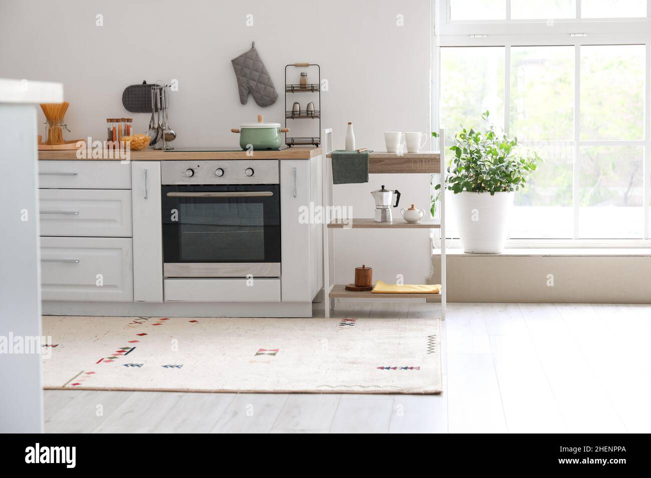 Interior of light kitchen with shelving unit Stock Photo - Alamy