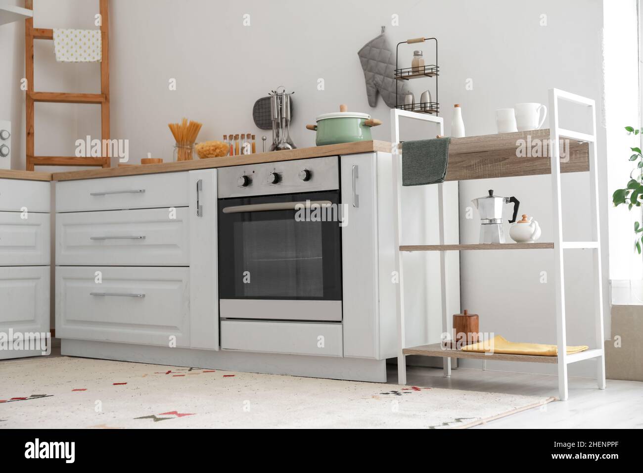 Interior of light kitchen with shelving unit Stock Photo - Alamy