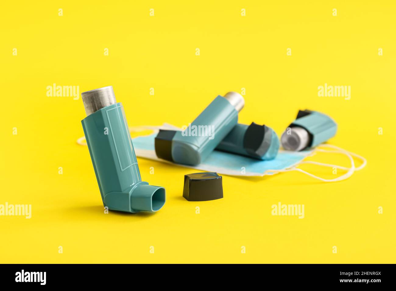 Asthma inhalers and mask on yellow background Stock Photo Alamy
