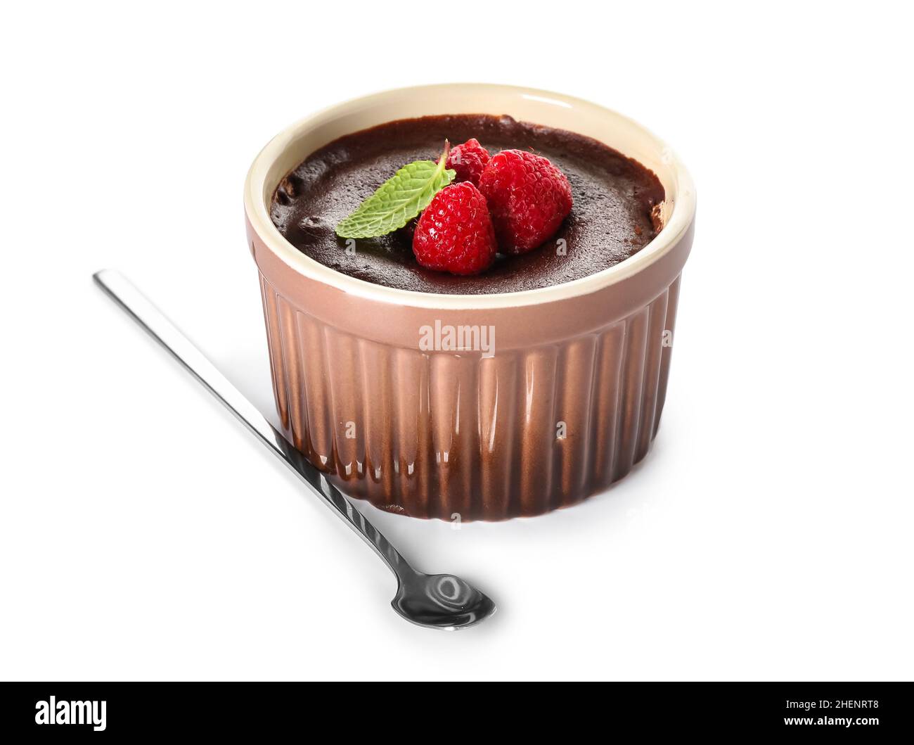 Ramekin with tasty lava cake fondant and raspberry on white background