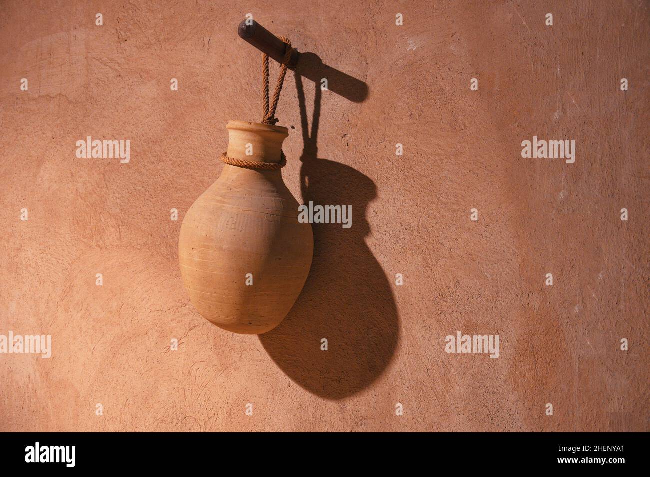 Handmade clay water jar hanging in traditional village house Stock