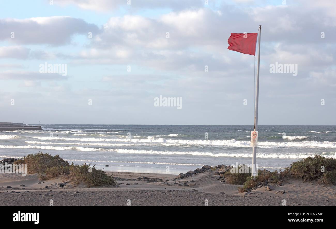 Red flag warning on beach in Spain (Lanzarote Stock Photo Alamy