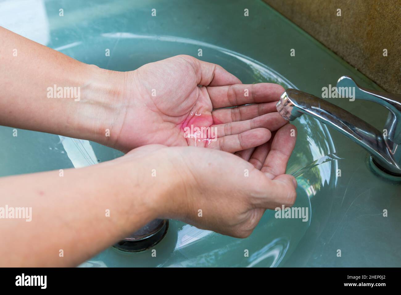 man washing hands before eating Stock Photo