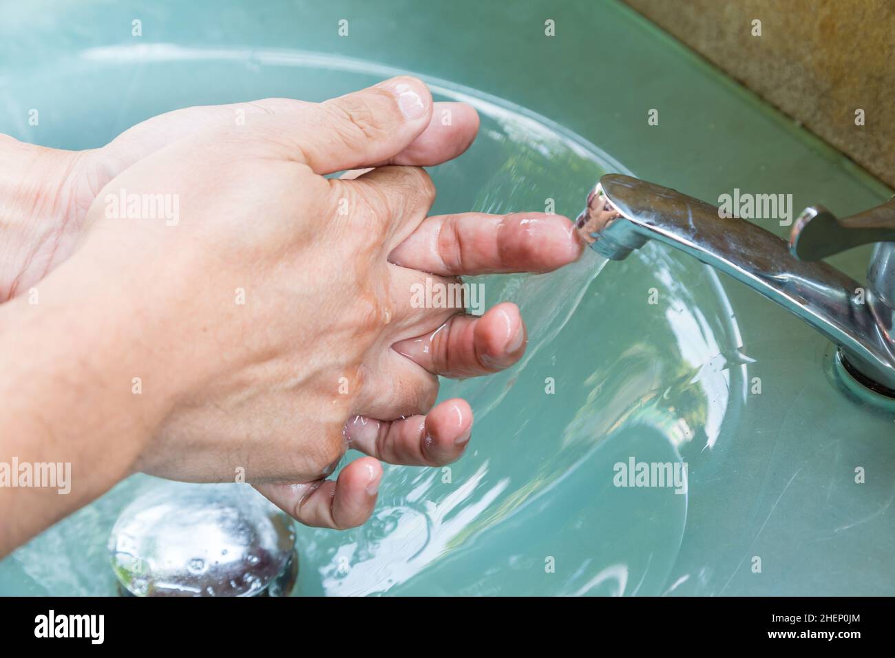man washing hands before eating Stock Photo