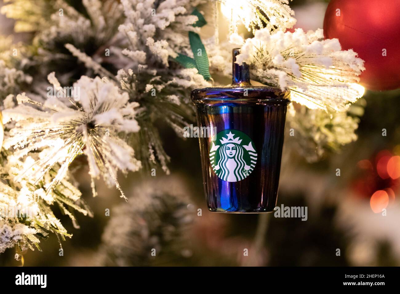 A Starbucks Christmas ordainment is seen on a Christmas tree at a Coffeehouse during the holiday season. Stock Photo