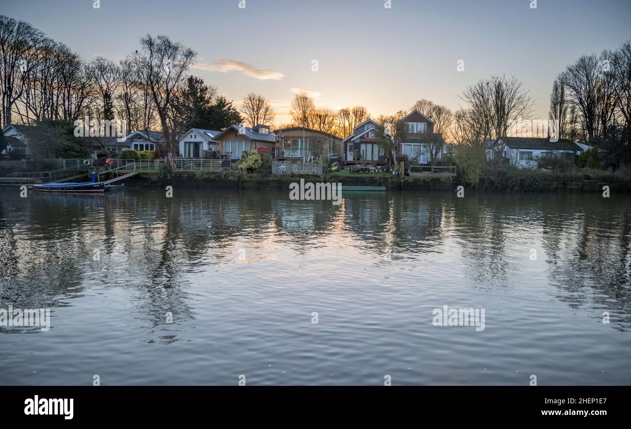 a collection of houses on eel pie island on the river thames at