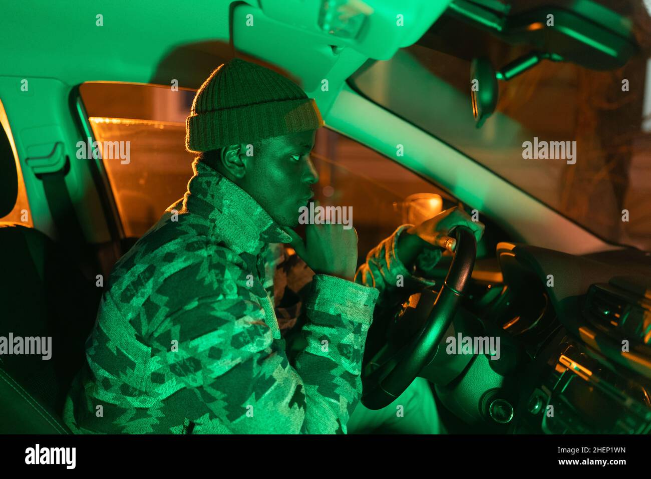 Depressed african man sit in car in darkness think about breakup with girlfriend or problem at work Stock Photo