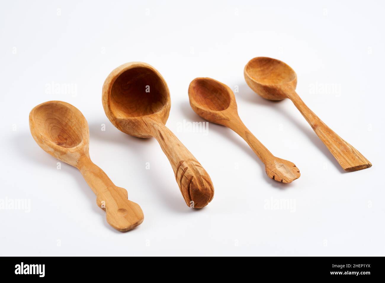 Handcrafted wooden spoons and ladle isolated on white background Stock